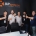 Five men in a conference room raise champagne glasses for a toast in front of an APsystems backdrop reading 'APsystems Alt Energy Power'.